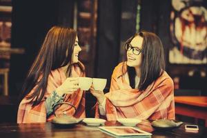 Two young and beautiful girls gossiping photo