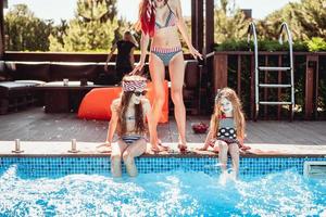 Happy mother and two daughters have fun photo