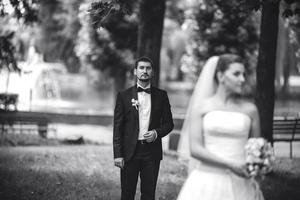 groom standing behind the bride photo