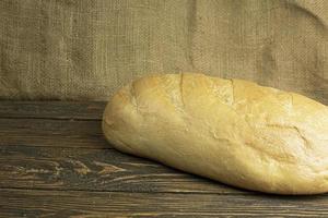 Fresh handmade bread on wooden background photo