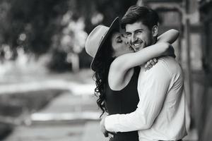 beautiful girl embraces and kisses her boyfriend photo