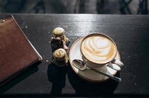 Coffee shop coffee in a white mug with a leaf design photo