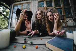 Three vintage witches perform magic ritual photo