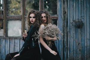 Two vintage witches gathered eve of Halloween photo