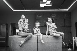 Mom, two daughters and a little son on the couch photo