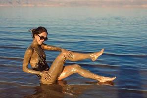 A young woman enjoying the natural mineral mud photo