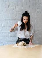 Young girl poured cappuccino on the table photo