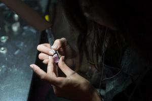 girl master processes the metal plate in the home workshop photo