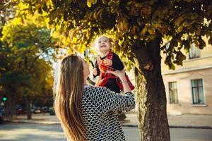 Mother and little daughter playing in a park photo