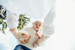 Mother and little daughter playing in a park photo