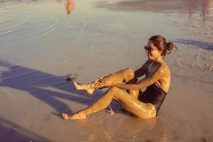 A young woman enjoying the natural mineral mud photo