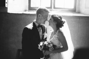 bride and groom on the background of a window. photo