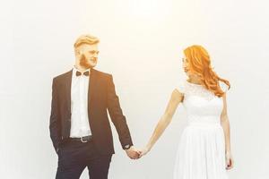 Wedding couple on a background of whitewall photo
