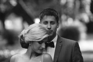 Beautiful wedding couple posing in the park photo