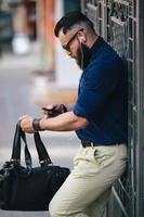 bearded man standing and listening to music photo