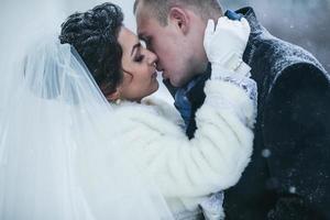 Bride and groom walking on the European city in the snow photo