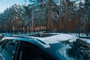 Drone standing on the roof of a snow-covered car photo