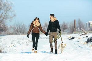 Young couple in love walking with dog photo