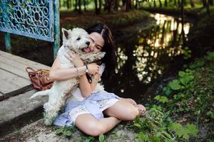 girl playing with a dog photo