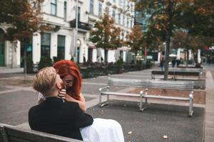 Wedding couple sitting on a bench in a futuristic building photo