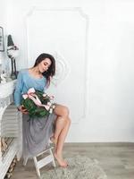 Young woman sitting on a chair photo