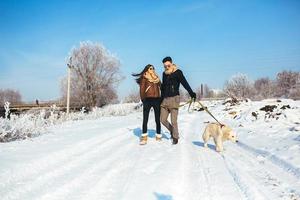 Young couple in love walking with dog photo