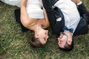 Wedding couple lying on the grass photo