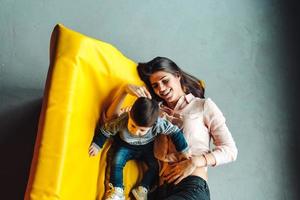 Mother and little son play at home photo