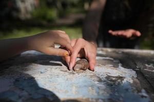 girl with a snail in the garden photo