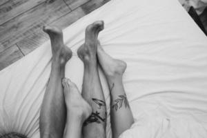 Young adult couple lying on bed photo