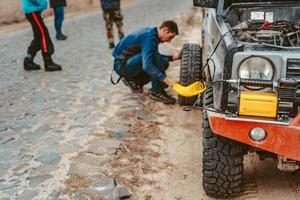 A man pumps air wheel with a compressor photo