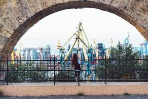 Little girl playing at fence photo