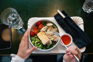 Healthy breakfast bowl with porridge and fresh vegetable salad photo