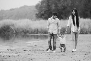 Young family walking at the beach photo