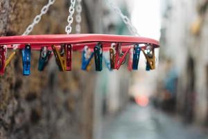 old white plastic clothespins hang photo