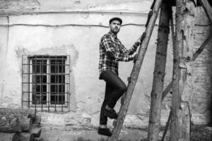 man in selvedge jeans standing on the ladder photo