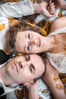 wedding couple lying under a tree photo