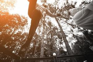 bride and groom jumping, having fun photo