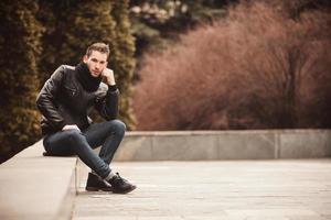 Fashion male model on the bench photo