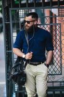 bearded man standing and listening to music photo