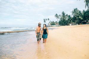 a guy and a girl are walking along photo