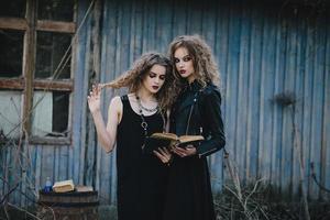 Two vintage witches gathered eve of Halloween photo