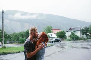 beautiful couple hugging in the rain photo