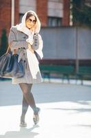 girl in a coat on the street photo