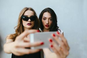 Two girlfriends taking a selfie photo