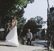 bride and groom posing on the streets photo