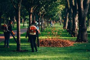 People operating a heavy duty leaf blower. photo