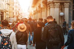 Unrecognizable mass of people walking in the city photo