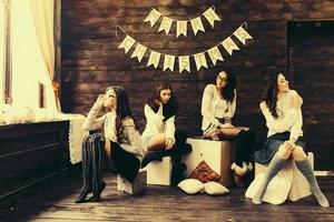 Four charming model posing on a vintage New Year's background photo