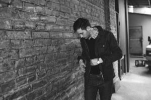 Male model in jeans on the background of a brick wall photo